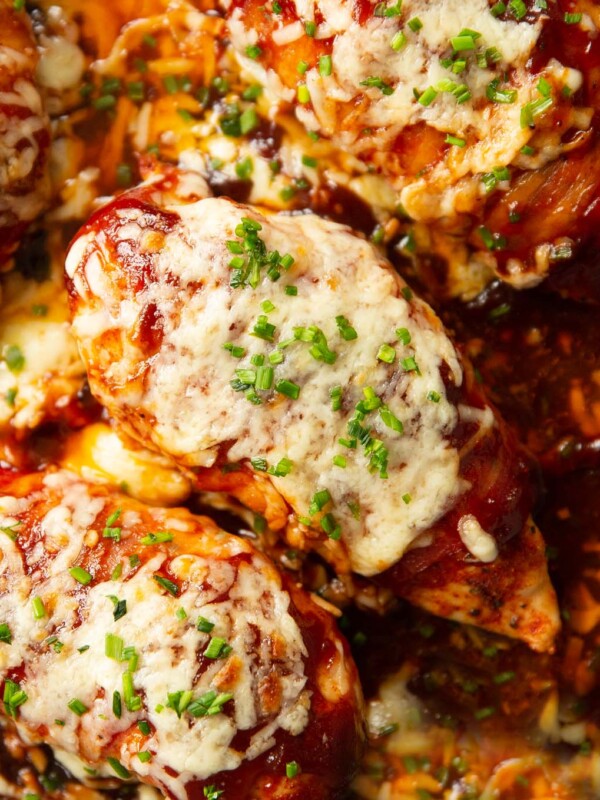 close up overhead shot of hunters chicken in skillet garnished with chives