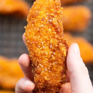 close up overhead shot of hand holding cornflake chicken