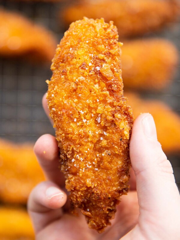 close up overhead shot of hand holding cornflake chicken