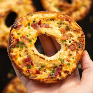 close up overhead shot of hand holding bagel showing filling