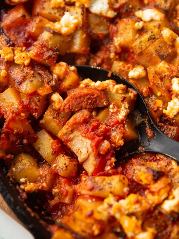 close up shot of black serving spoon digging in to chicken chorizo bake