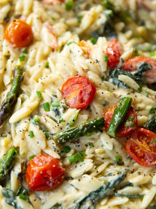 close up shot of baked feta orzo in large pan