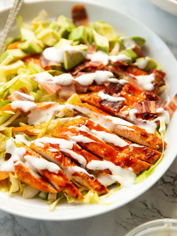 buffalo chicken salad served with ranch in large white shallow dish