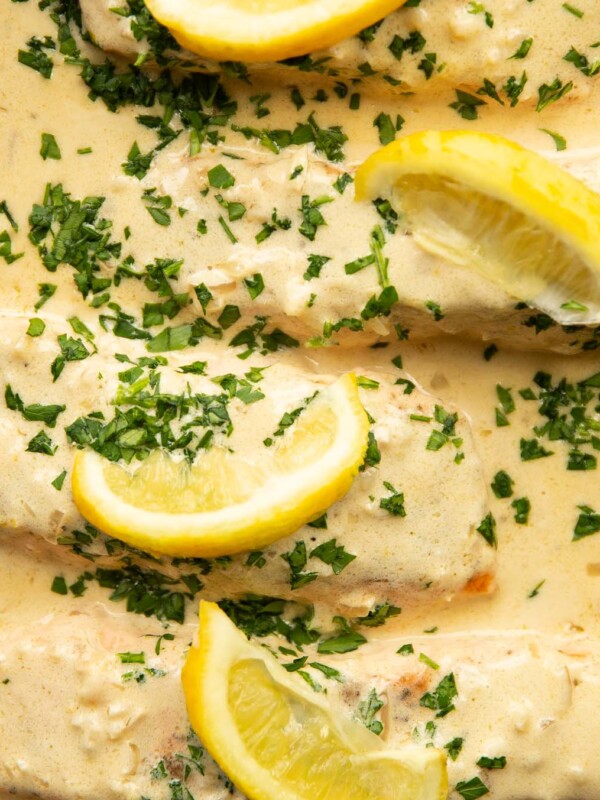 overhead shot of 4 salmon fillet sin lemon cream sauce in pan