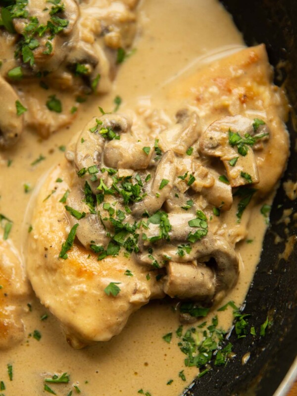 close up shot of chicken marsala in pan garnished with parsley