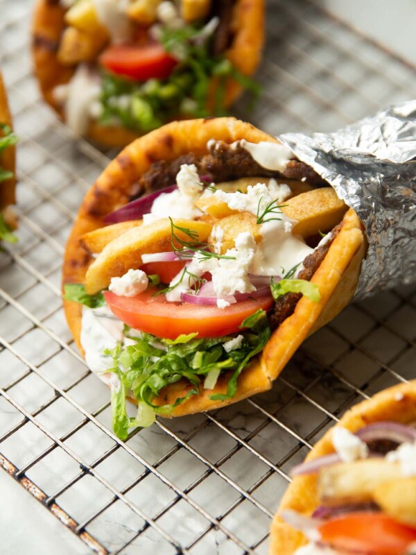 close up shot of ground beef gyros on wire rack in foil