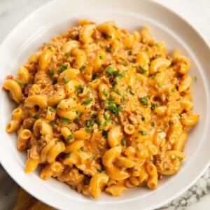 hamburger helper served in a large white bowl with fresh chives