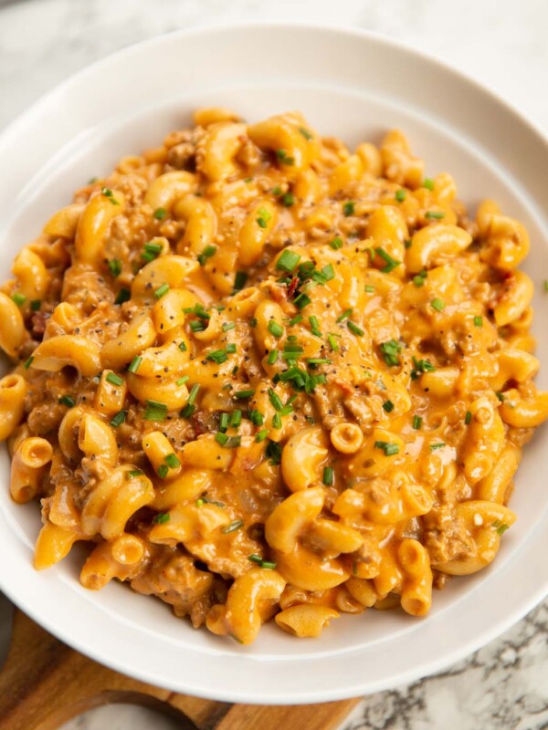 hamburger helper served in a large white bowl with fresh chives