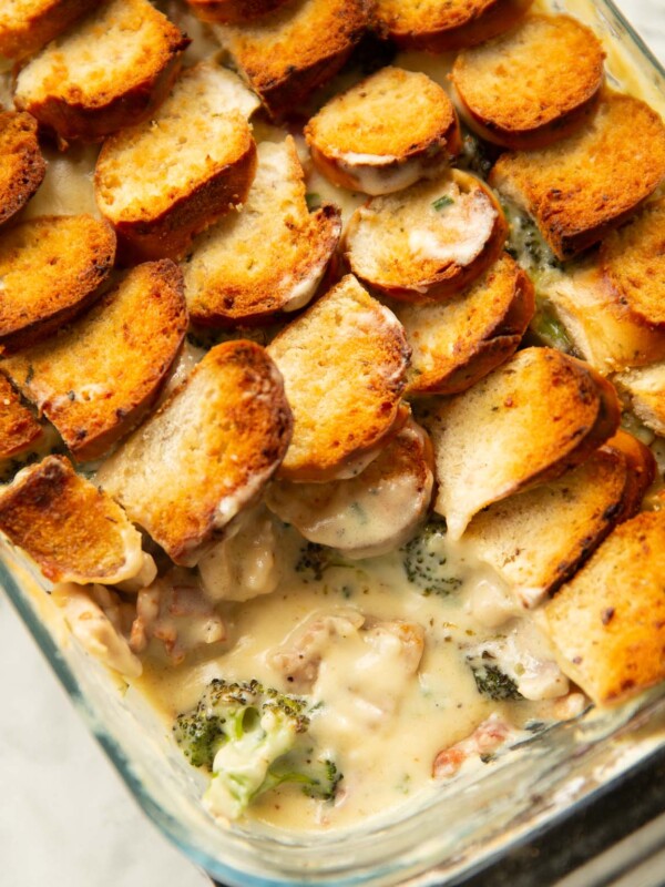 close up shot of cheesy chicken broccoli bake with scoop taken out