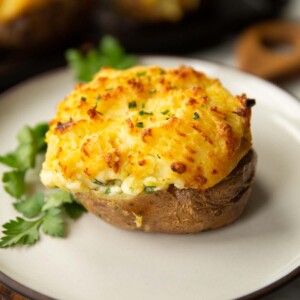 fish pie baked potato on white plate with parsley