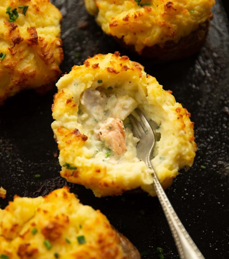 overhead shot of silver fork digging in to fish pie jacket potatoes