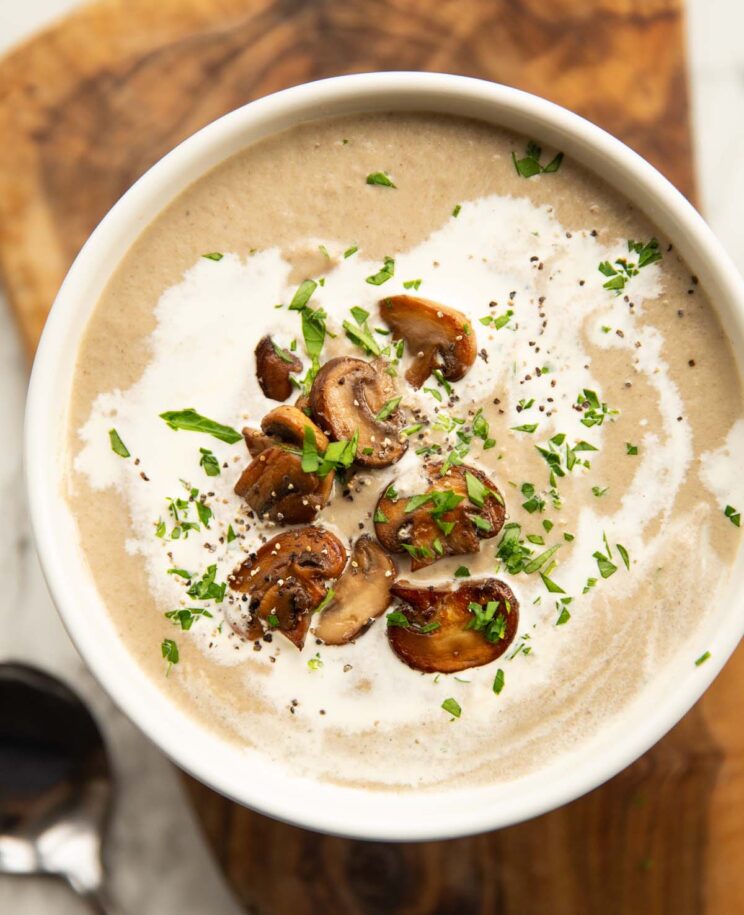 close up overhead shot of creamy mushroom soup in small white bowl