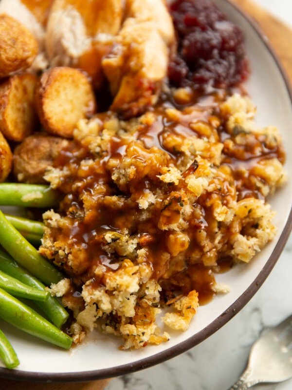 sage and onion stuffing with gravy on small white plate