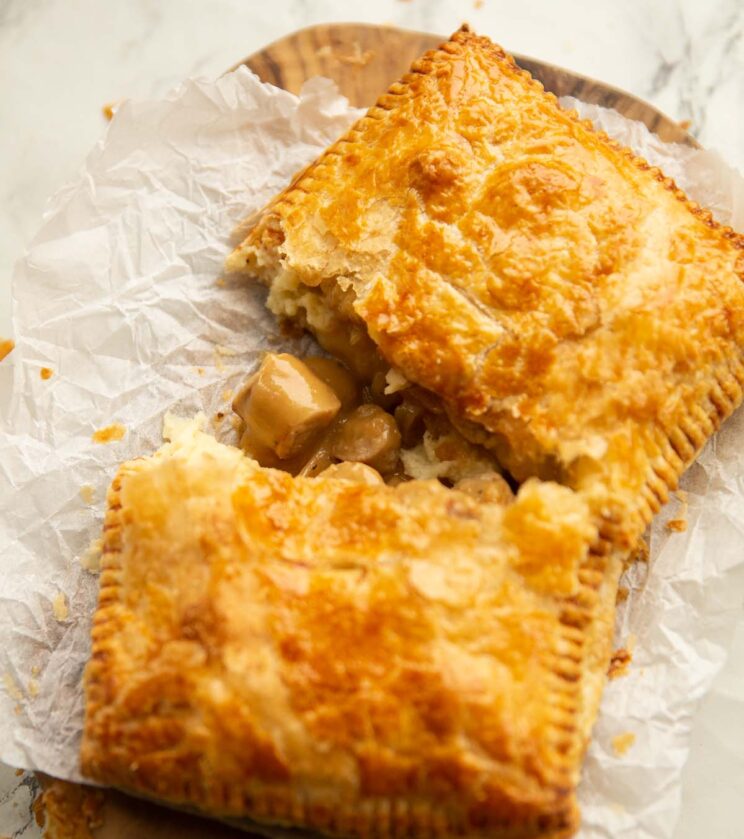 close up shot of halved bangers and mash bake on scrunched up baking paper