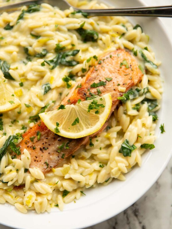 boursin salmon orzo served in large white bowl with lemon and fresh parsley