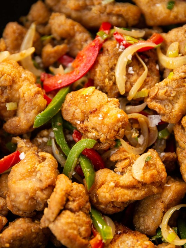 close up shot of salt and chilli chicken in black wok