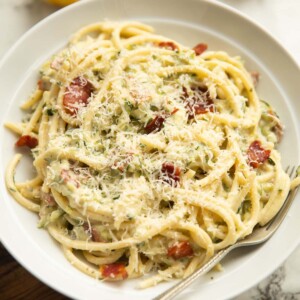 creamy courgette pasta served in a large white dish with silver form