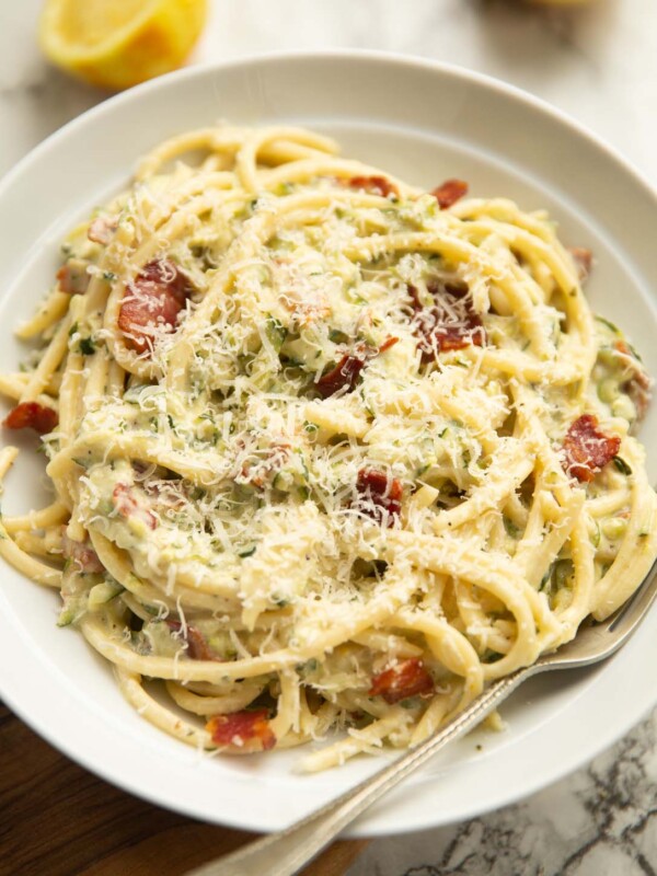 creamy courgette pasta served in a large white dish with silver form