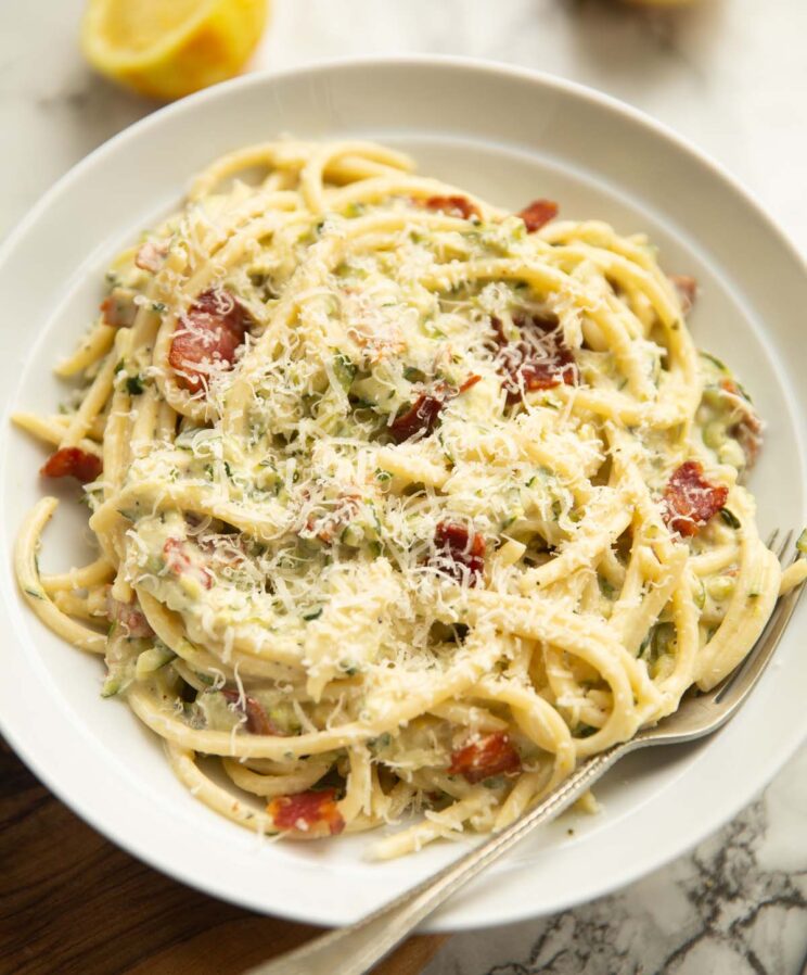 creamy courgette pasta served in a large white dish with silver form