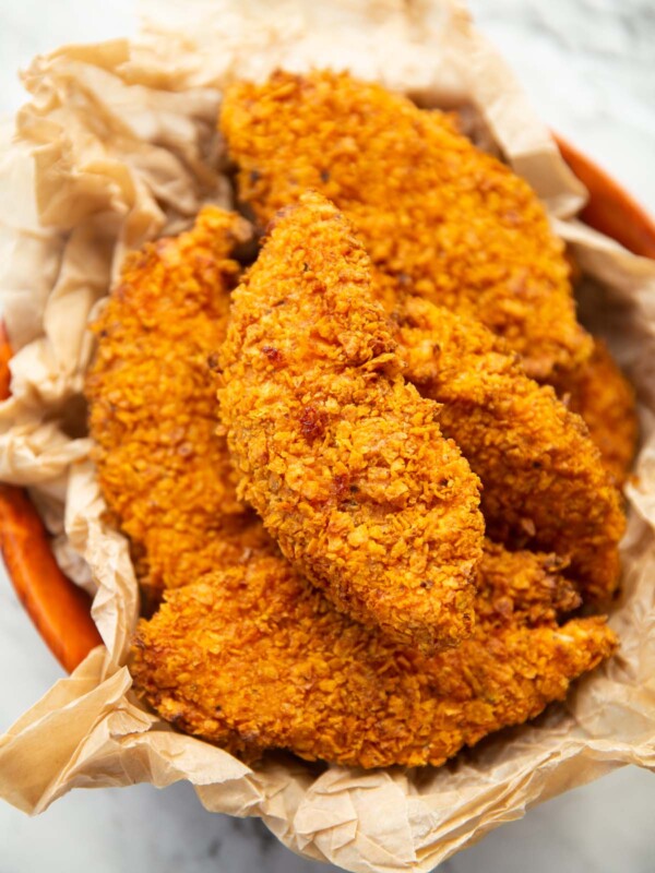 close up shot of Doritos chicken tenders in bowl with brown parchment paper