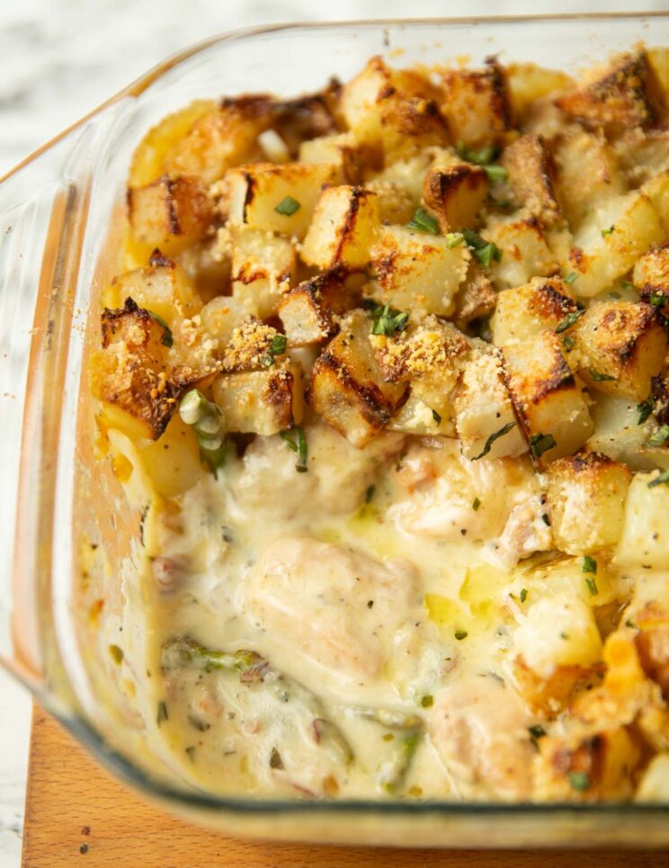 tarragon chicken bake with portion scooped out showing filling in glass baking dish