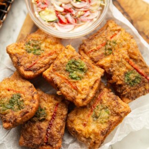 overhead shot of thai pork toast on wooden board with dipping sauce