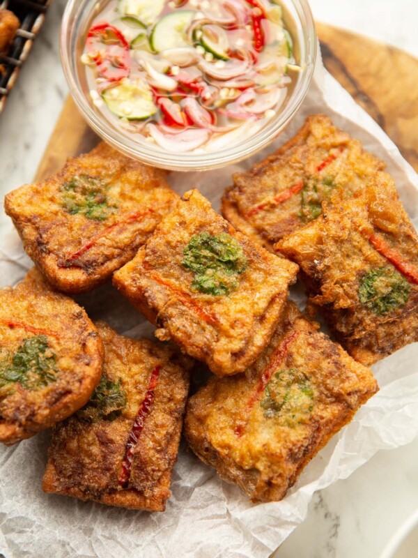 overhead shot of thai pork toast on wooden board with dipping sauce