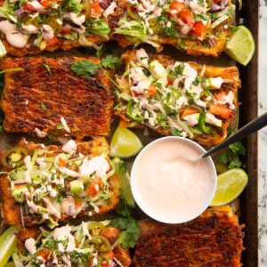 overhead shot of puff pastry tacos on large tray with small pot of taco sauce