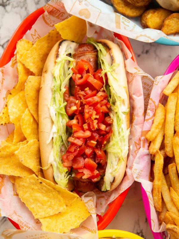 blt hot dog served with tortilla chips in red basket