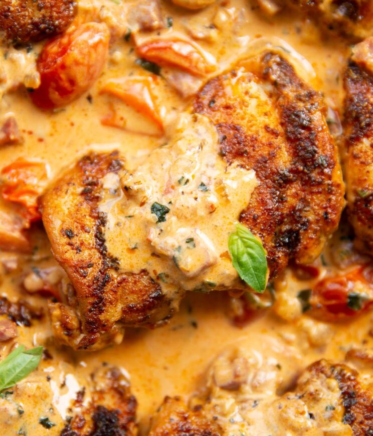 close up overhead shot of creamy chicken and chorizo garnished with basil