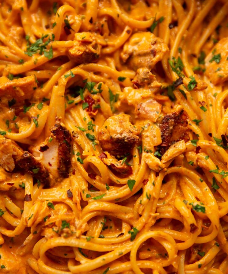 close up overhead shot of spicy tomato salmon pasta in large pan