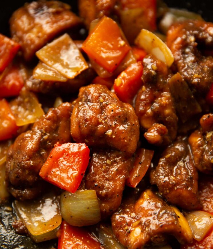 close up shot of black pepper chicken in pan