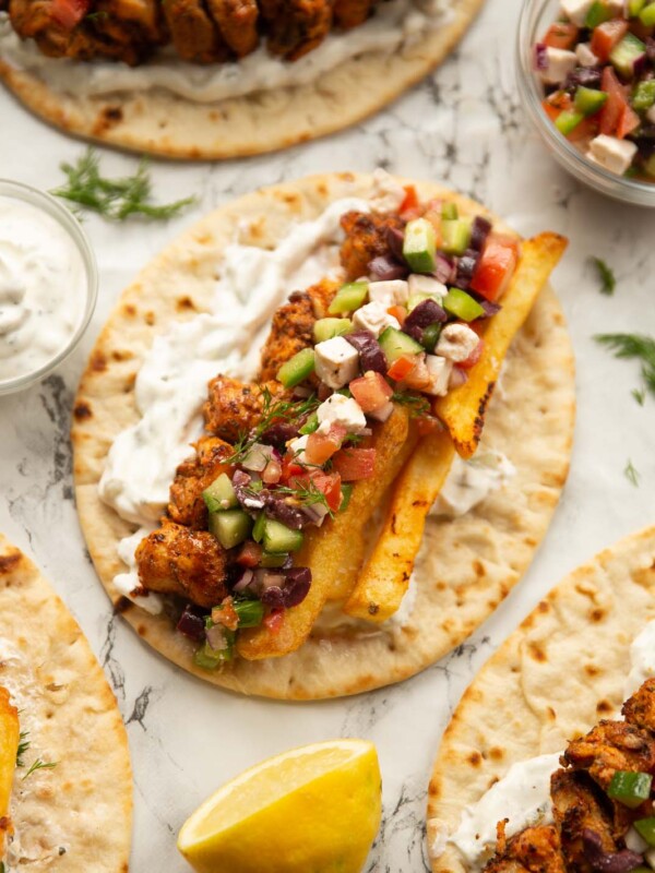 overhead shot of unfolded chicken souvlaki on marble backdrop