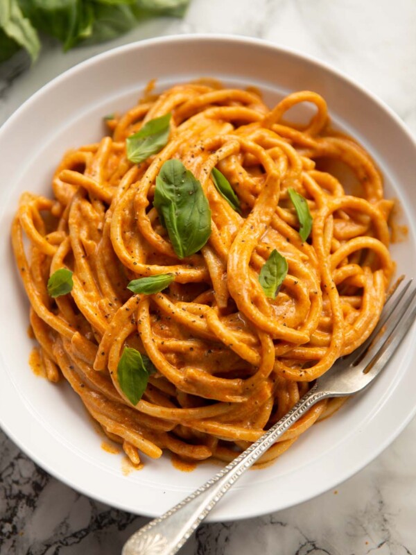 cottage cheese pasta served in white bowl with fresh basil