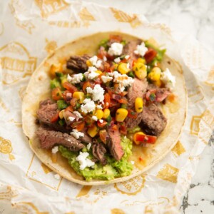 close up shot of steak taco on scrunched up paper