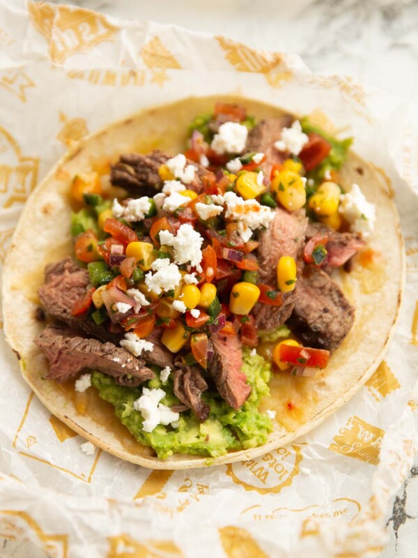 close up shot of steak taco on scrunched up paper