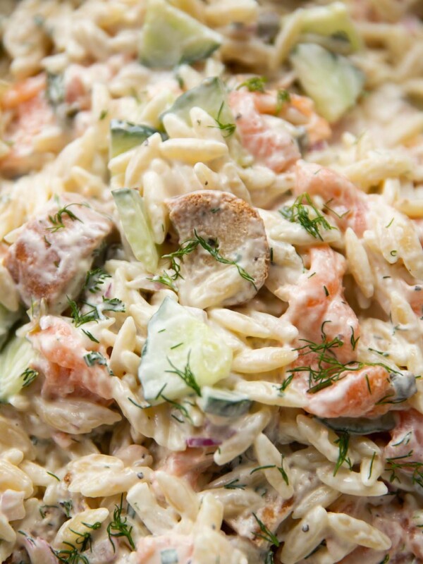 close up shot of salmon pasta salad garnished with dill