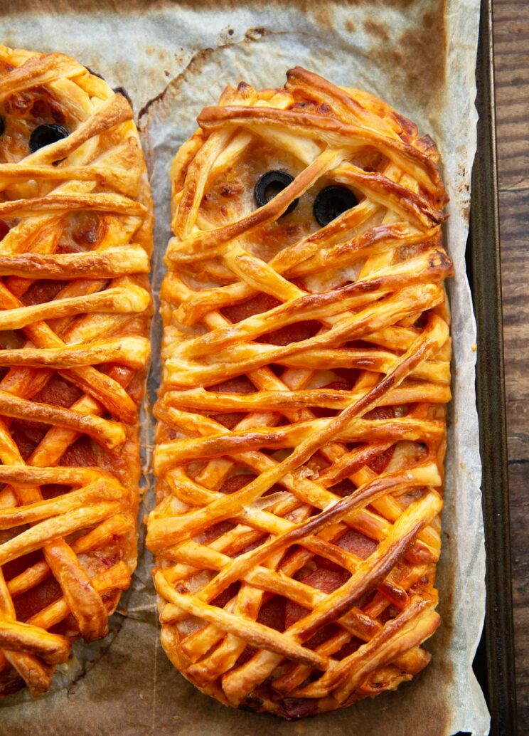 close up overhead shot of pizza mummies fresh out the oven on baking tray