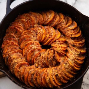 cajun butter sweet potato spiral in cast-iron pan fresh out the oven