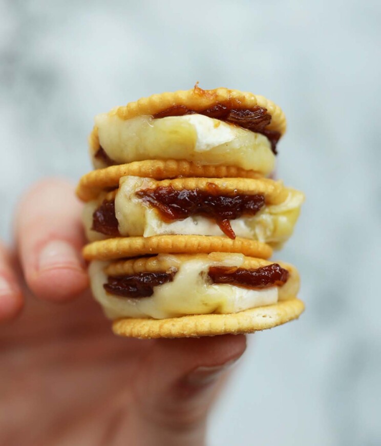 close up overhead shot of hand holding 3 ritz smores