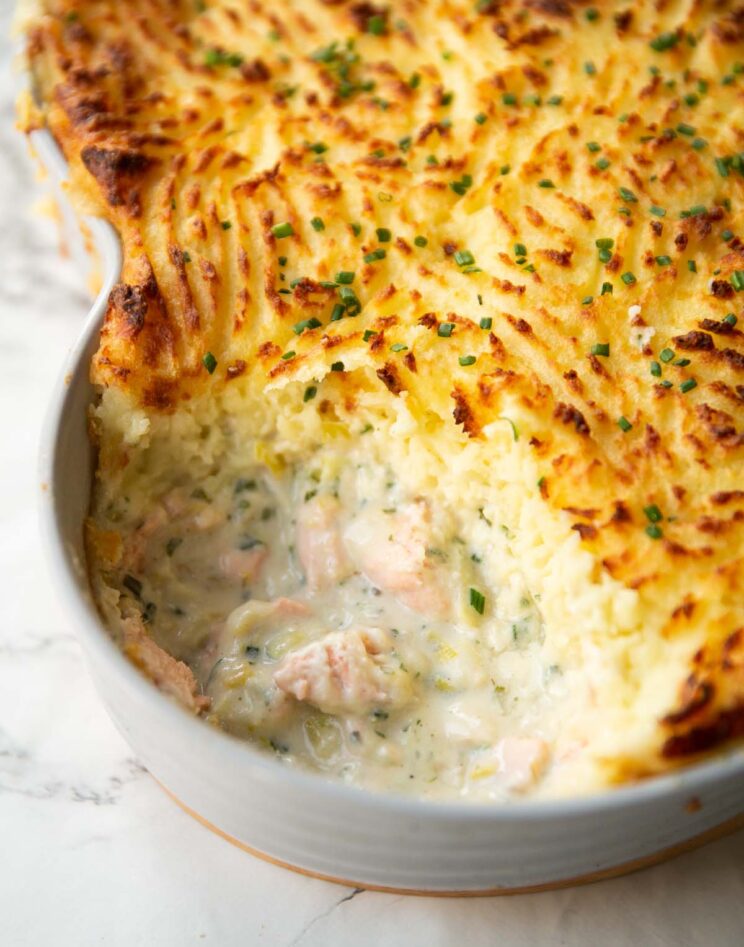 close up shot of creamy fish pie with portion taken out showing filling