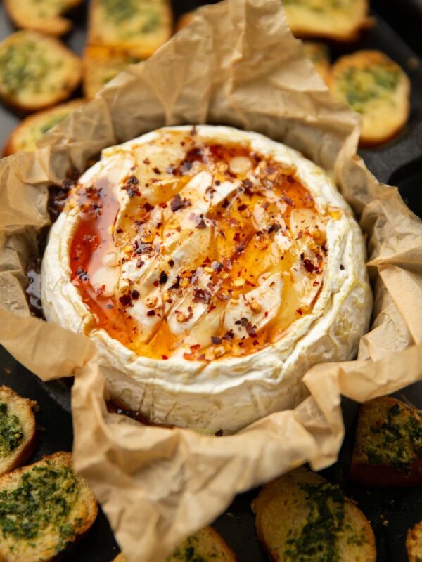 hot honey baked camembert on baking tray with bagel chips