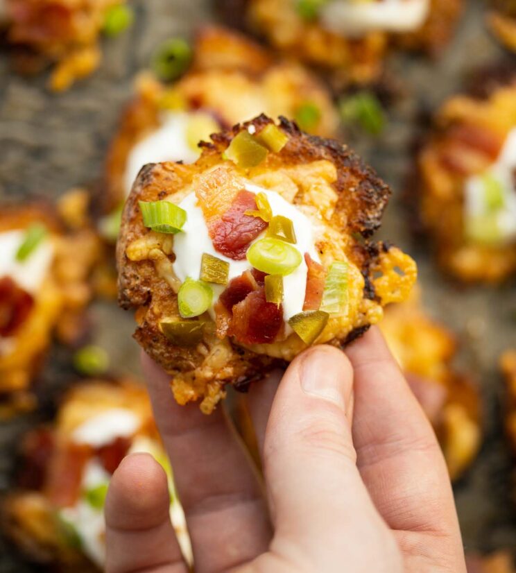 close up overhead shot of hand holding loaded smashed potato