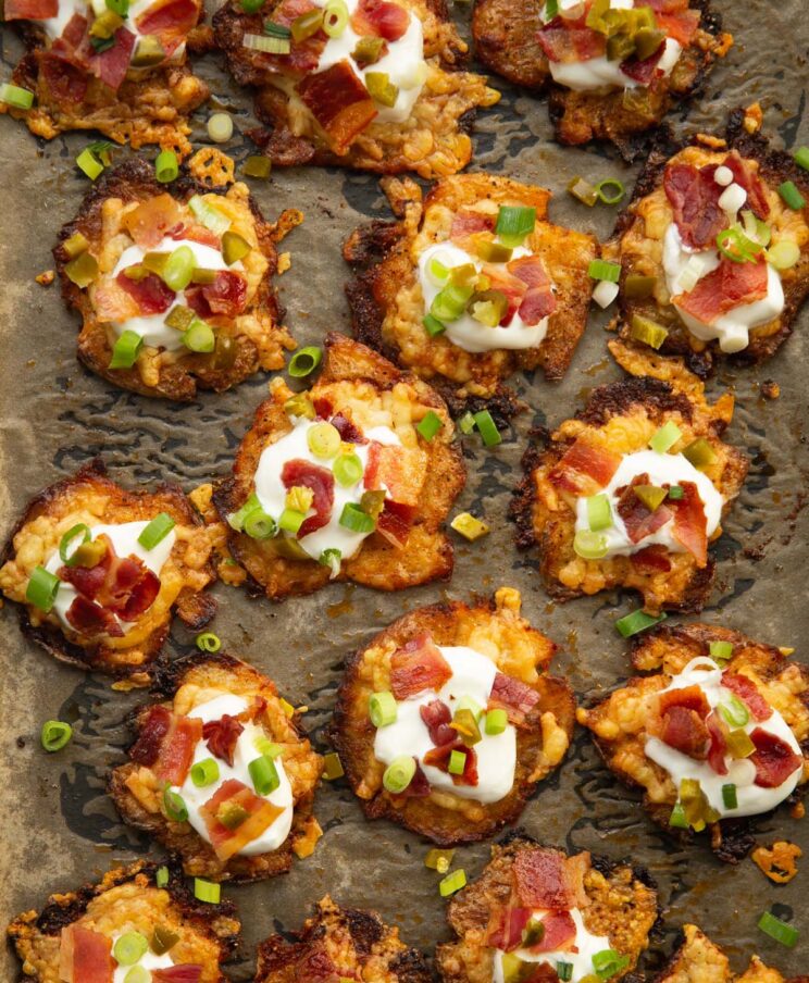 overhead shot of loaded smashed potatoes on baking tray