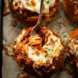 overhead shot of fork digging into pasta bread bowl