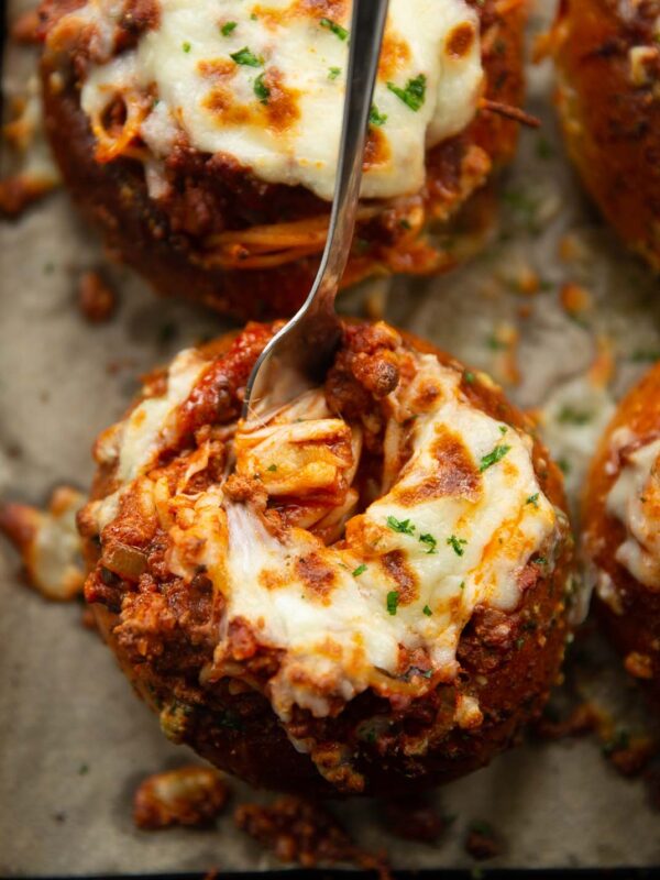 overhead shot of fork digging into pasta bread bowl