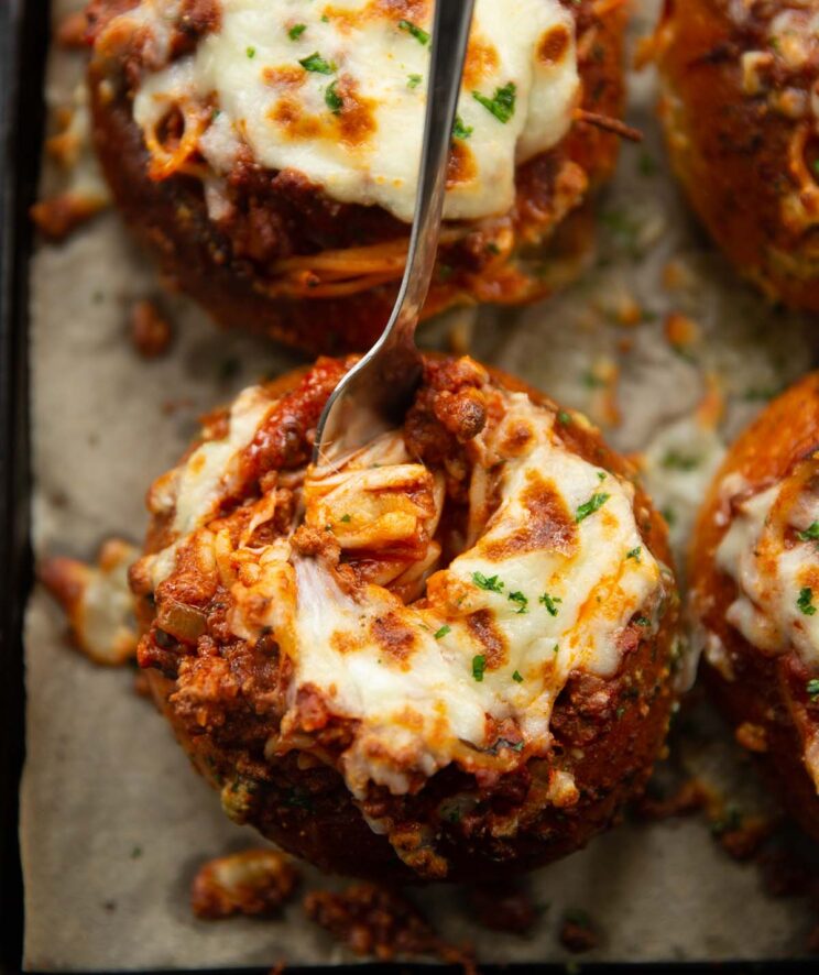 overhead shot of fork digging into pasta bread bowl