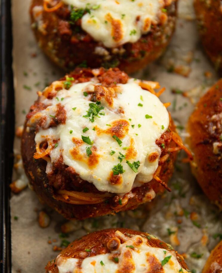 close up overhead shot of pasta bread bowls fresh out the oven garnished with parsley