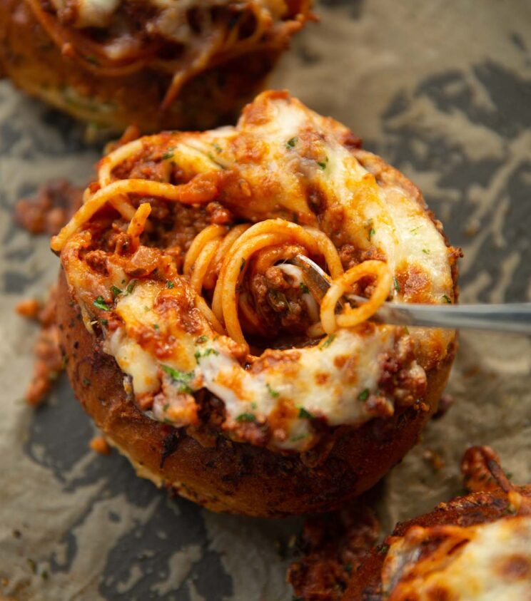 close up shot of spaghetti bread bowl with fork digging in